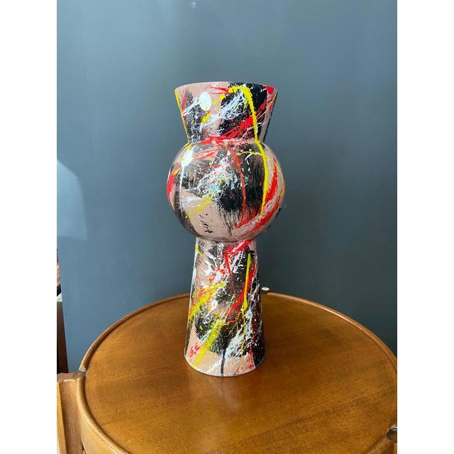 Metal vase in shades of pink, red, yellow, white and black created by the international artist Silvio Formichetti, a...