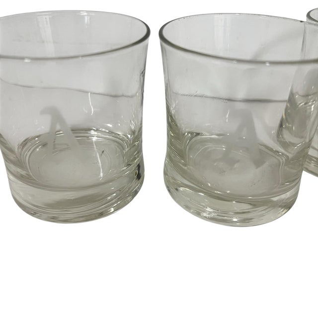 Vintage mid century etched monogrammed “A” lowball whiskey glasses. Glass is wavy and appears to be blown. Each measures...
