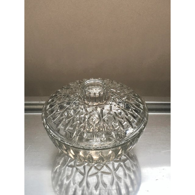 A round crystal covered dish made in the mid 20th century in radiating floral medallion around a starburst and...