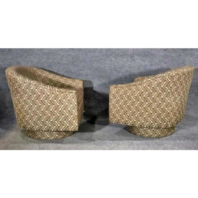 Pair of vintage modern round back lounge chairs. Fully covered chair and base that swivels. Item number: SS106-052523