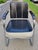 This streamline Art Deco springer club chair features gorgeous jet black wood armrests and vinyl upholstery with white...