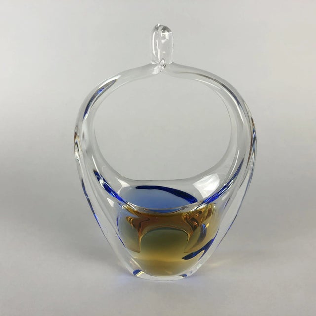 Basket made of clear metallurgical glass with sealed colored decor. metallurgical glass of organic shapes from glass...