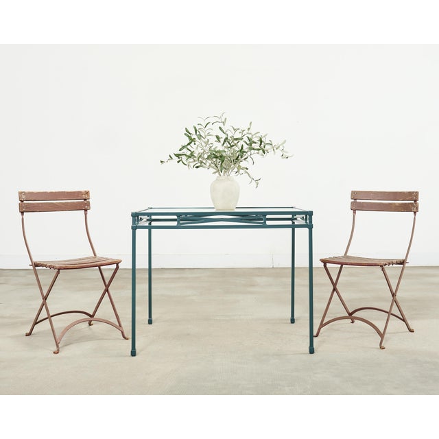 Weathered set of ten mid-century modern cafe/bistro dining chairs perfect for the patio or garden. The chairs feature a...