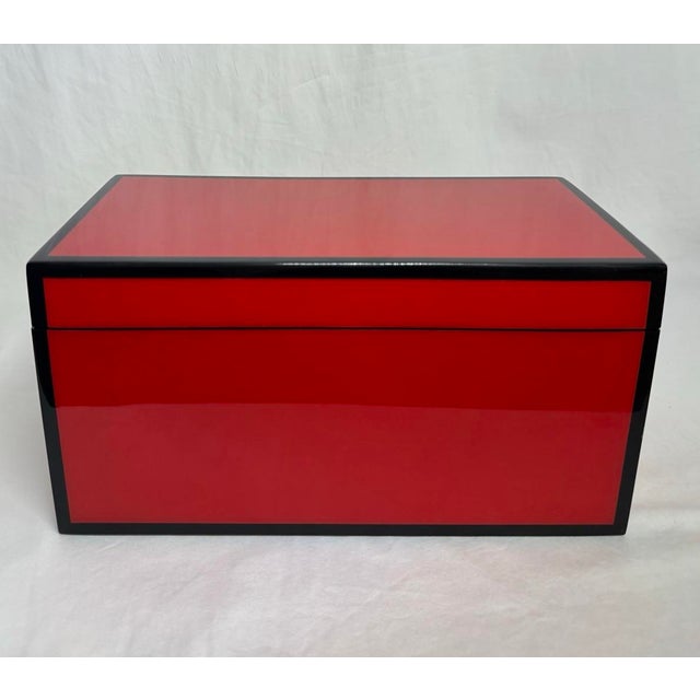 Lacquer trinket box in a striking Chinese red color with black border trim. Finished in several layers of lacquer, giving...