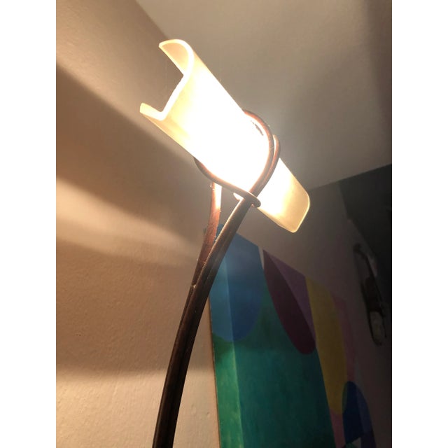 Super chic Italian bronze patina elongated wall sconce having sinuous silhouette and frosted glass horizontal shade at the...