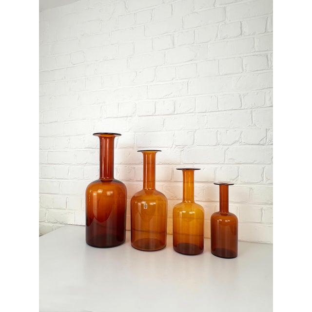 A striking graduated set of four amber gulvvase vases designed by otto brauer for holmegaard, denmark. designed in 1962,...