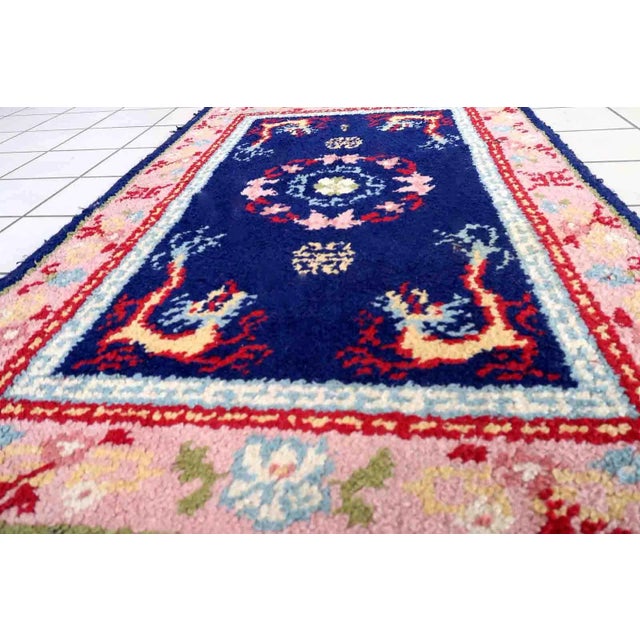 Vintage French Savonnerie rug in night blue and pink colors. The rug has been made in wool in the end of 20th century. It...
