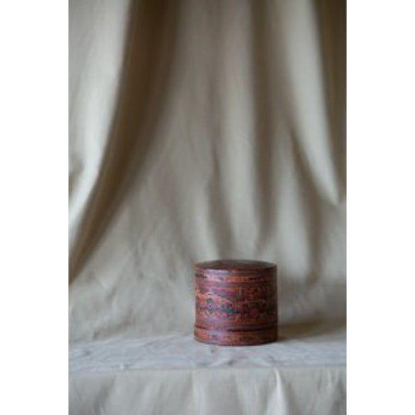 This antique Burmese betal box is made of lacquered cylindrical body of woven bamboo and intricate traditional folk art....