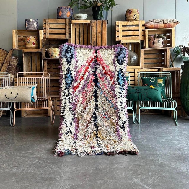 Immerse yourself in the rich tapestry of Moroccan culture with this exquisite Vintage Moroccan Berber Boucherouite Rug....