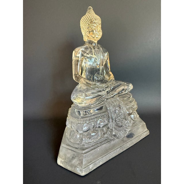 This charming 1970s lucite Buddha figure features a serene seated Buddha rendered in clear acrylic atop an ornate lotus...