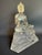 This charming 1970s lucite Buddha figure features a serene seated Buddha rendered in clear acrylic atop an ornate lotus...