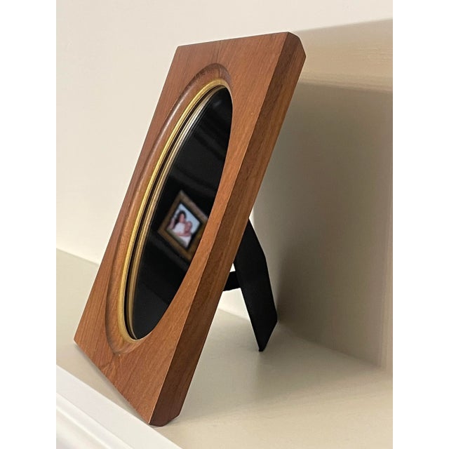 There's versatility in this solid walnut wood frame as it can be used as a table top accent mirror or picture frame.The...
