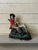 Hand painted cast iron doorstop depicting a colonial scene of seated hunting man and dog. Heavy and well made.