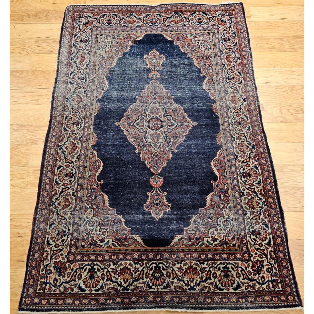 "This exquisite vintage Persian Kashan rug, hand-knotted in the early 1900s, showcases the meticulous artistry and...