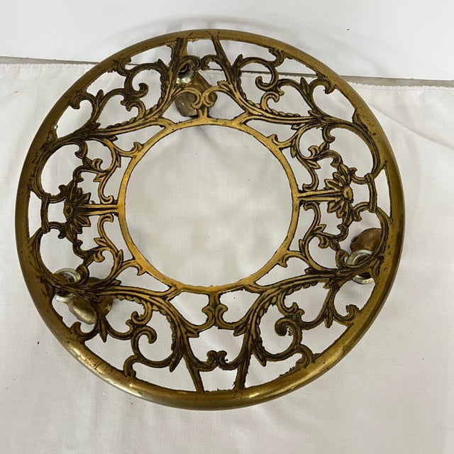 Brass reticulated rolling plant stand caddy. Measures 11.25” x 2.25”. 3 wheels.