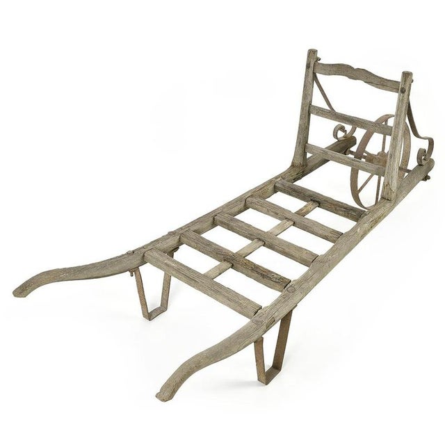This 19th century wheelbarrow is distinguished by its wooden structure embellished with metal elements, testifying to...