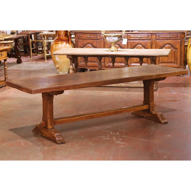 Hand-crafted in southern France circa 1860, this substantial antique refectory table embodies the robust architectural...