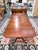 Substantial solid wood dining table featuring a traditional double pedestal base with gracefully curved tripod legs. The...