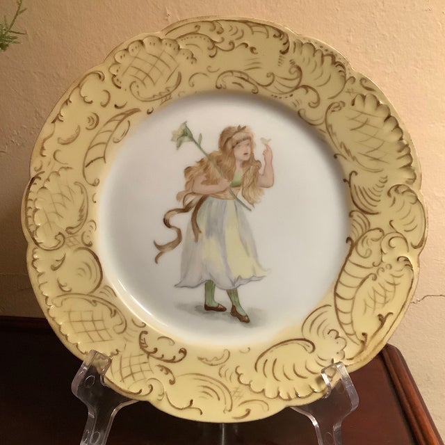 Truly a beautiful find. A unique hand painted fairy wearing a flowing dress holding a bird in her left hand and a single...