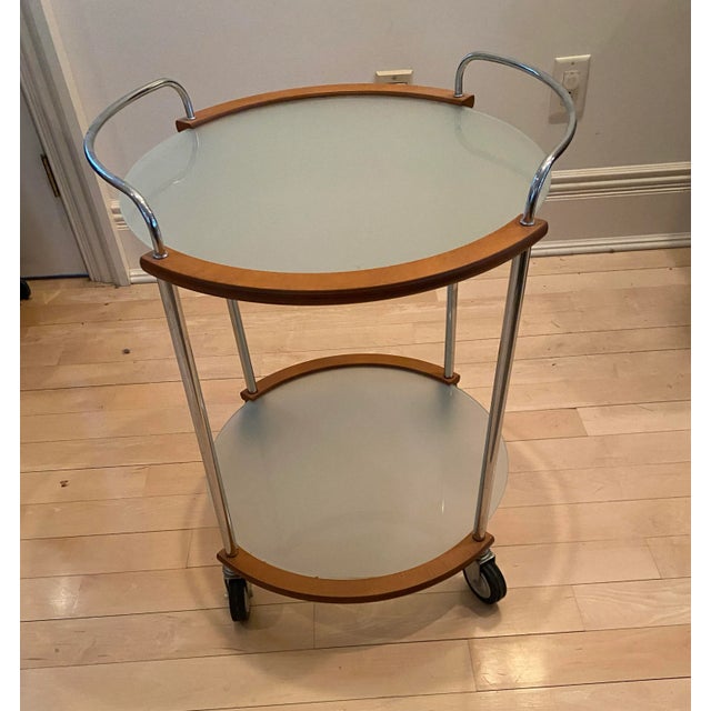 Wood and Sterling Bar Cart with 2 level frosted glass shelves and wood and sterling trim. The wheels enable this cart to...