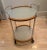 Wood and Sterling Bar Cart with 2 level frosted glass shelves and wood and sterling trim. The wheels enable this cart to...
