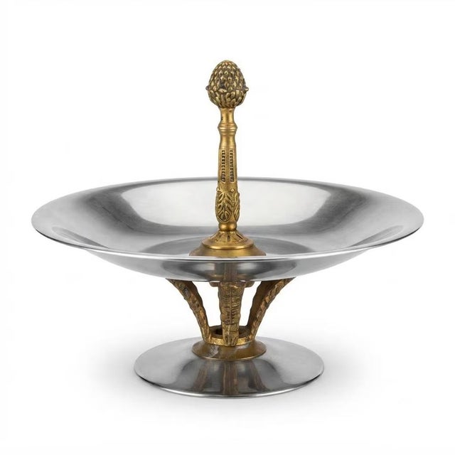 1960s pedestal bonbonniere with a shallow silver-toned metal bowl, brass leaf-form supports and a central brass handle...