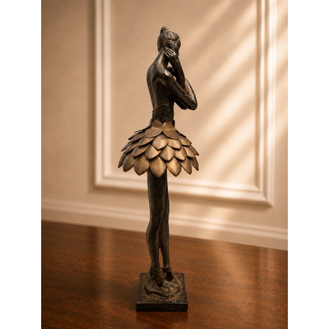 Graceful and sophisticated, this authentic Uttermost bronze finish ballerina sculpture brings timeless elegance to any...
