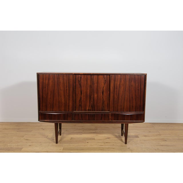 This highboard was designed by E. W. Bach for the Danish furniture manufacturer Sejling Skabe during the 1960s. The piece...