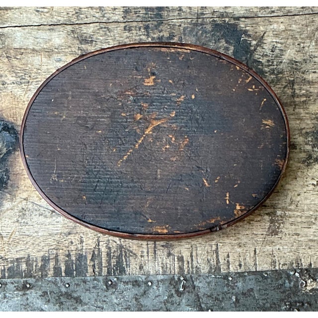 This vintage Shaker-style wooden oval box is a timeless expression of handcrafted American folk design, celebrated for its...