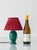 A small, jewel-toned French Art Deco table lamp from the 1930s, its emerald base paired with a new garnet silk pleated...