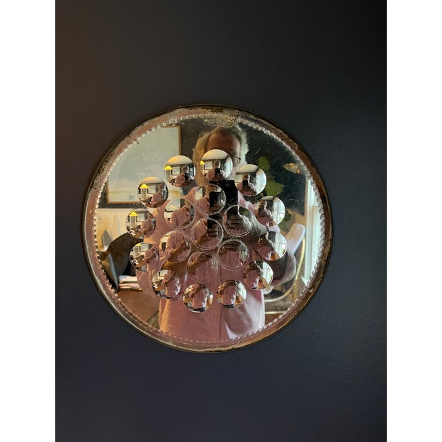 Fornasetti optical mirror. Circular mirror with iconic bubble design. Nicely etched rim and original antiqued patina in...
