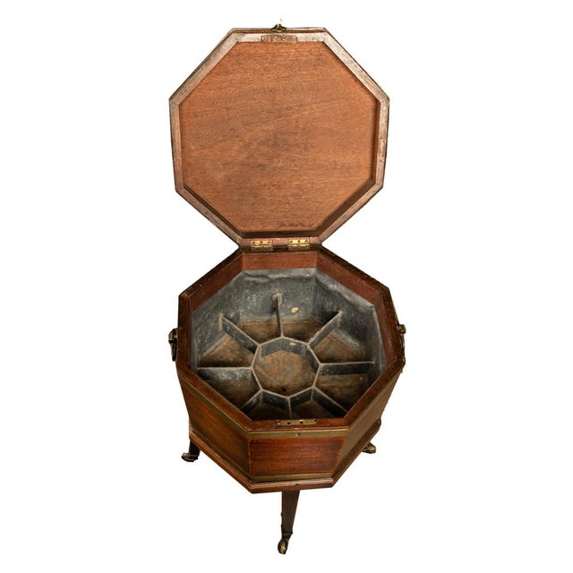 The cellarette in two sections is of octagonal form and made from solid mahogany, the hinged locking top (key present)...