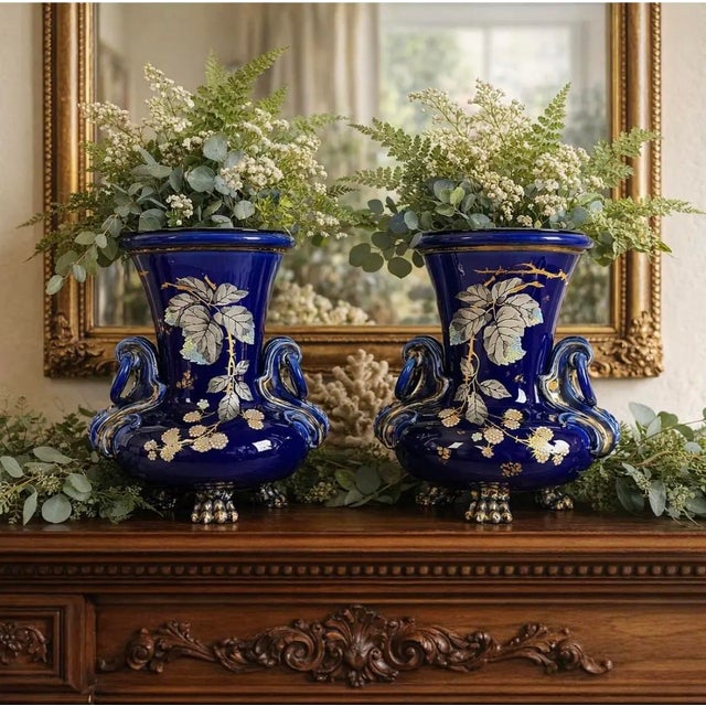 An exceptionally striking pair of antique cobalt blue faience jardinieres or decorative urns, richly detailed with...