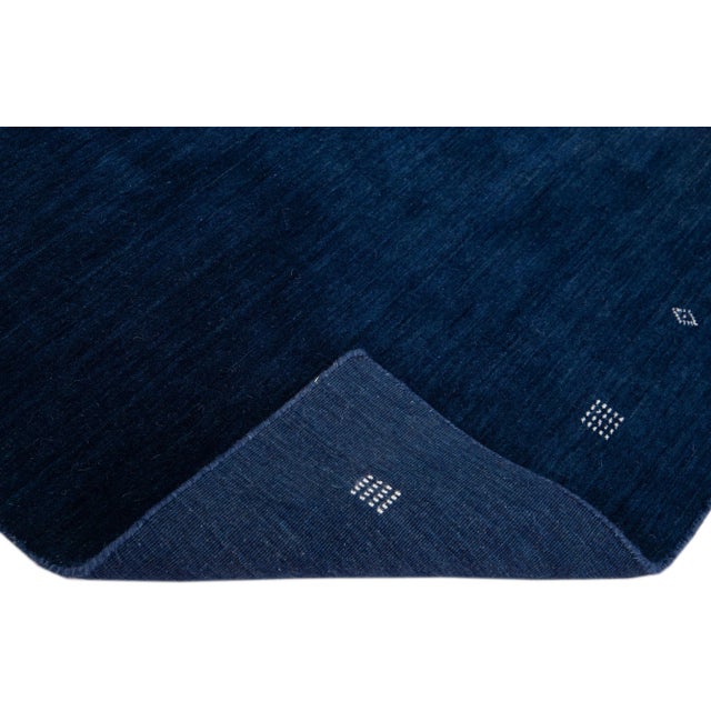 Beautiful modern Gabbeh Style hand-Loom wool rug with a navy blue field with gorgeous minimalist design. This rug...