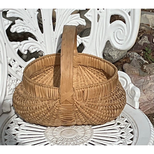 Woven Primitive buttock honey-colored basket.