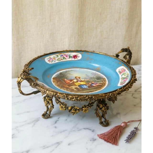 Large antique 19th-century Sèvres-style porcelain centerpiece featuring a celestial blue ground with hand-painted floral...