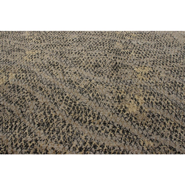 A 10x14 hand-knotted rug in distressed style from Rug & Kilim’s Homage Collection. This modern frame carries the hallmark...