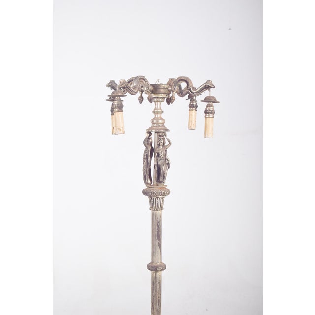 This elegant French floor lamp, crafted in silvered metal, dates from the early 20th century and features four light...