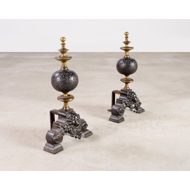 Distinctive pair Dutch Baroque style andirons crafted from patinated brass and iron. The large andirons feature round...