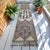 This striking 1970s hand-knotted runner rug originates from Southeastern Anatolia, woven authentically by villagers for...