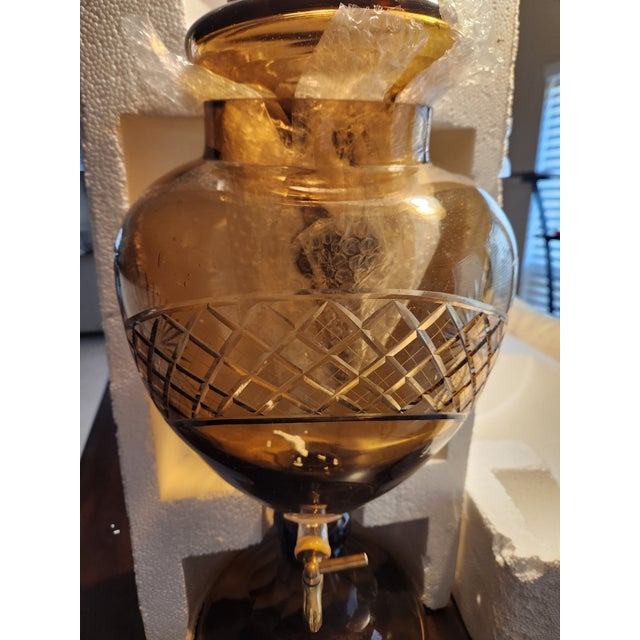 Elevate your next gathering with this exquisite Bohemian Amber Glass Beverage Dispenser. This statement piece blends Old...