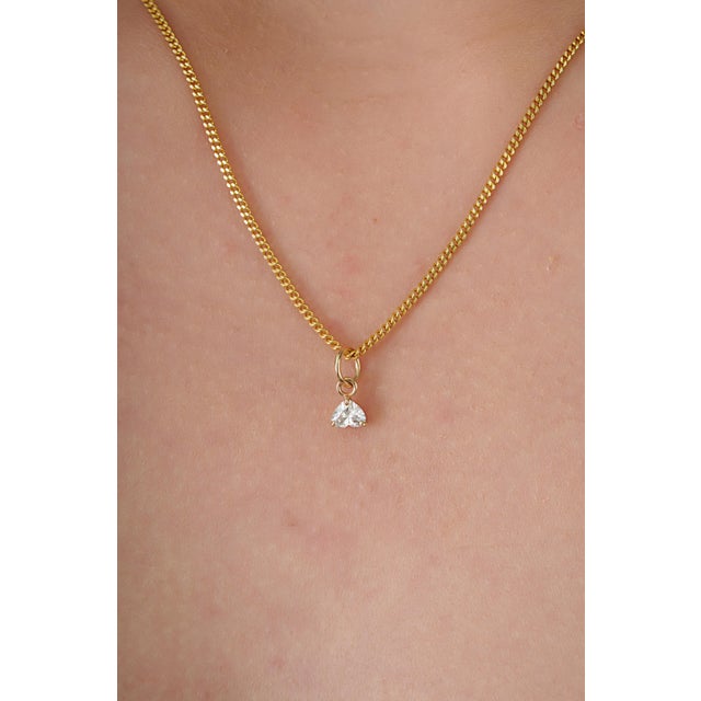 This elegant solitaire pendant features a 0.24 carat diamond set in 14k yellow gold. The diamond measuring 4.2 x 4.7 mm,...