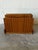 This freestanding magazine rack features an angled profile with dual storage compartments. A raised central divider...
