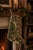 This vintage wool kilim stocking pairs a solid olive green lower body with a soft gray floral rosette pattern at the cuff,...