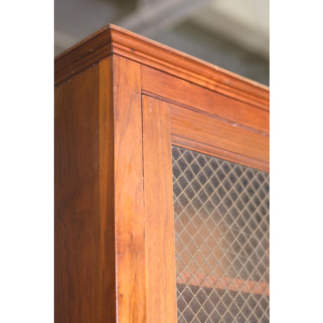 1960s walnut veneer kitchen storage cabinet. This cabinet has eight pieces: four upper shelving units with chicken wire...