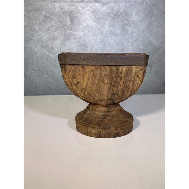 A rice and grain separator made of wood and iron, likely from India, can be repurposed into a candlestick or candle holder...