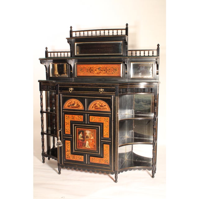 Aesthetic movement black lacquer and painted cabinet, circa 1880. The removeable top section with baluster turnings, a...