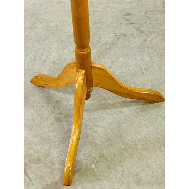 Vintage 1970s maple wood tall coat rack. The top of the rack spins and the base is a tripod style. No marks.