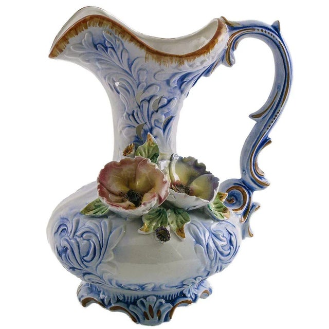 A modern Italian Capodimonte porcelain jug from the midcentury, 1930s, with handle decorated in baroque forms. The pitcher...