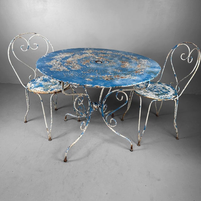 Elegant and characterful garden set from france, dating from the 1950s–60s. This rare ensemble includes eight chairs, a...